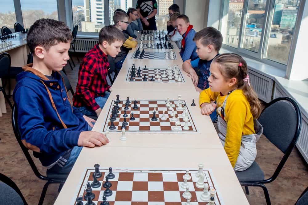 Kids play chess during chess competition