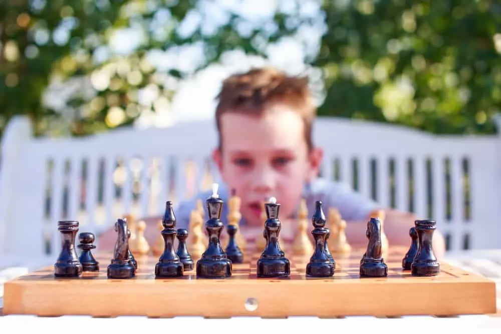 boy thinking over chess game