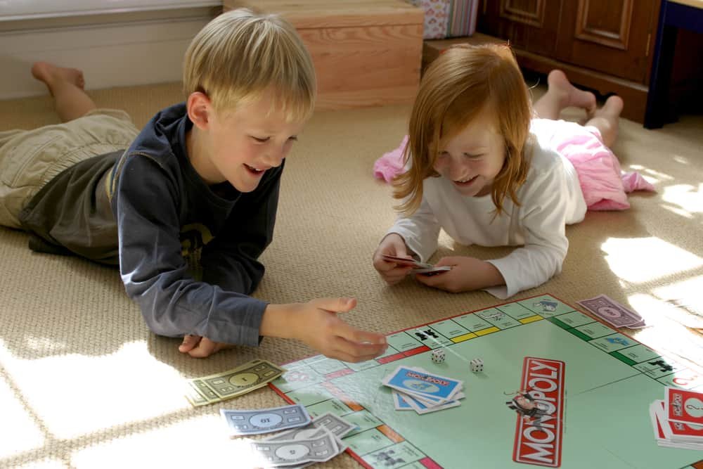 Kids having fun while playing Monopoly