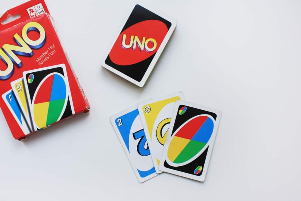 UNO card game with deck and playing cards on a table