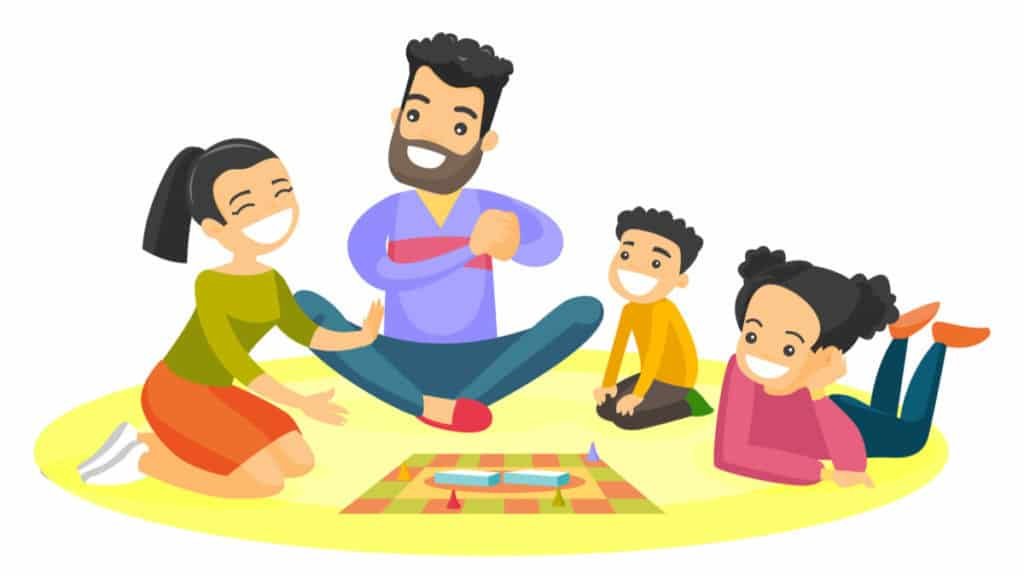 family sitting on the floor and playing together a board game at home