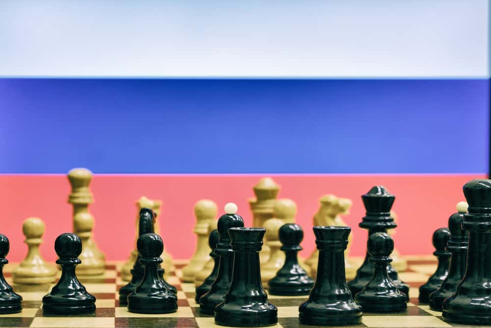 Russia flag on the background of chess with pieces on the Board