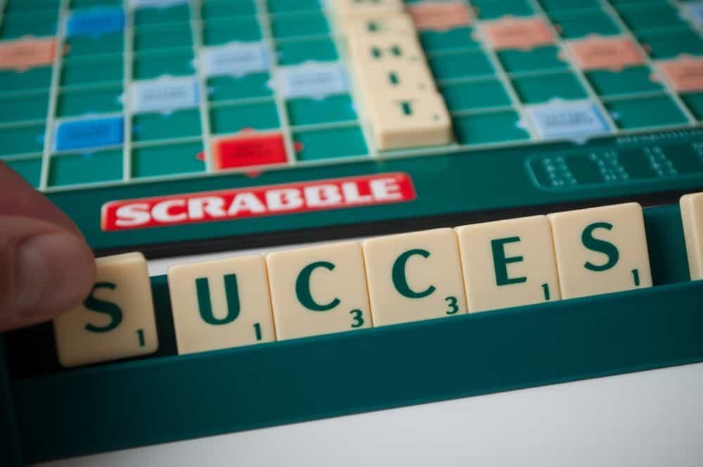 Closeup of plastic letters with word success on Scrabble board game