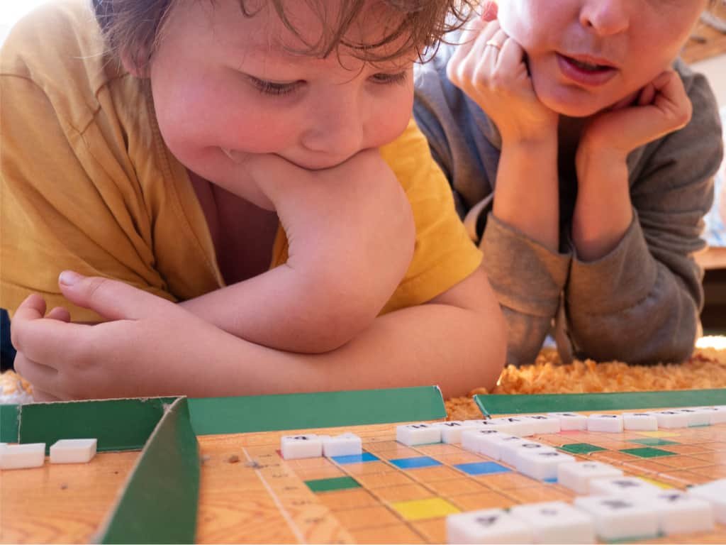Kid and mom playing a Russian version of Scrabble