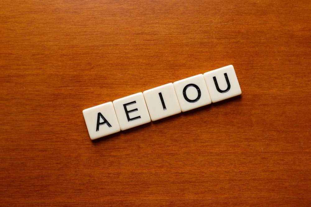 Scrabble - AEIOU vowel letters on a wood table