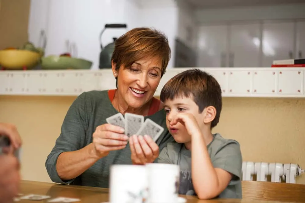 Grandmother and a grandchildren playing cards