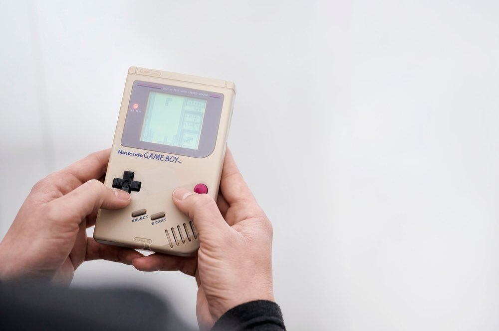 Nintendo Game Boy while playing the popular game Tetris