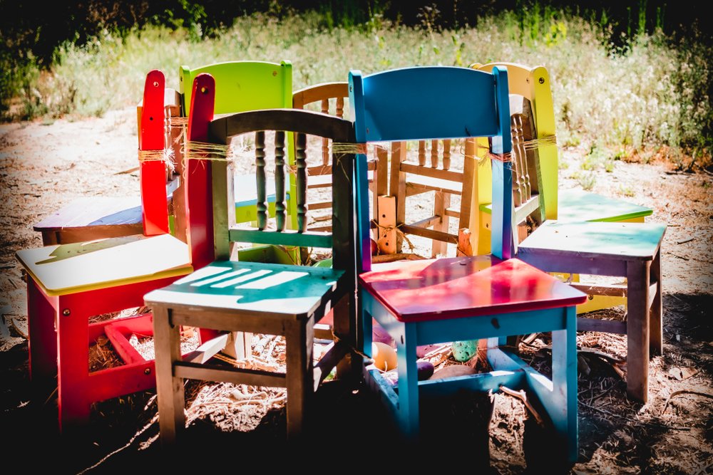 colorful children's wooden chairs tied in a circle