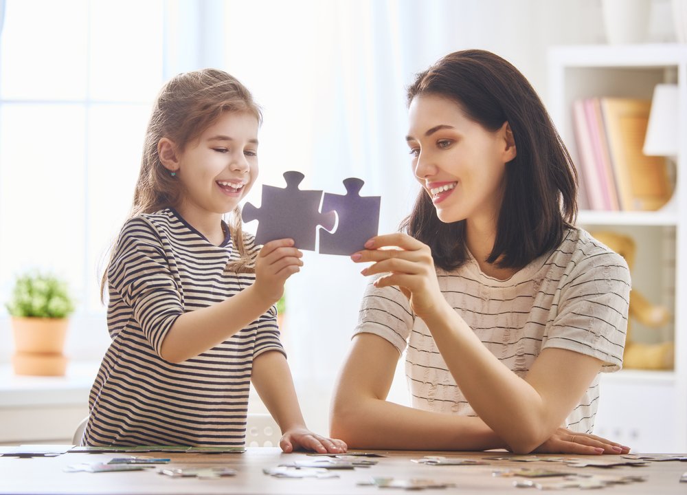 Mother and daughter do puzzles together