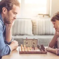 Father and son are playing chess