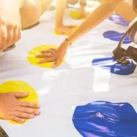 play a twister on the grass. Hands on yellow