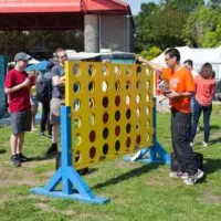 A group of men plays a giant-sized game of Connect Four at the Forks