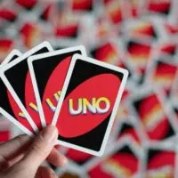 Deck of Uno game cards scattered all over on a table