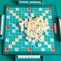 Top view of pile of letter tiles on board of Scrabble game