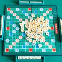 Top view of pile of letter tiles on board of Scrabble game